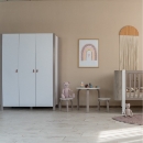 a room with a crib and a crib and a crib
